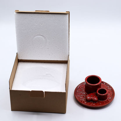 Red ceramic incense burner with a heart design on a white background