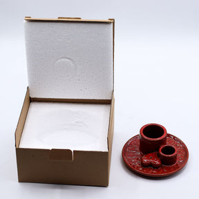 Red ceramic incense burner with a heart design on a white background