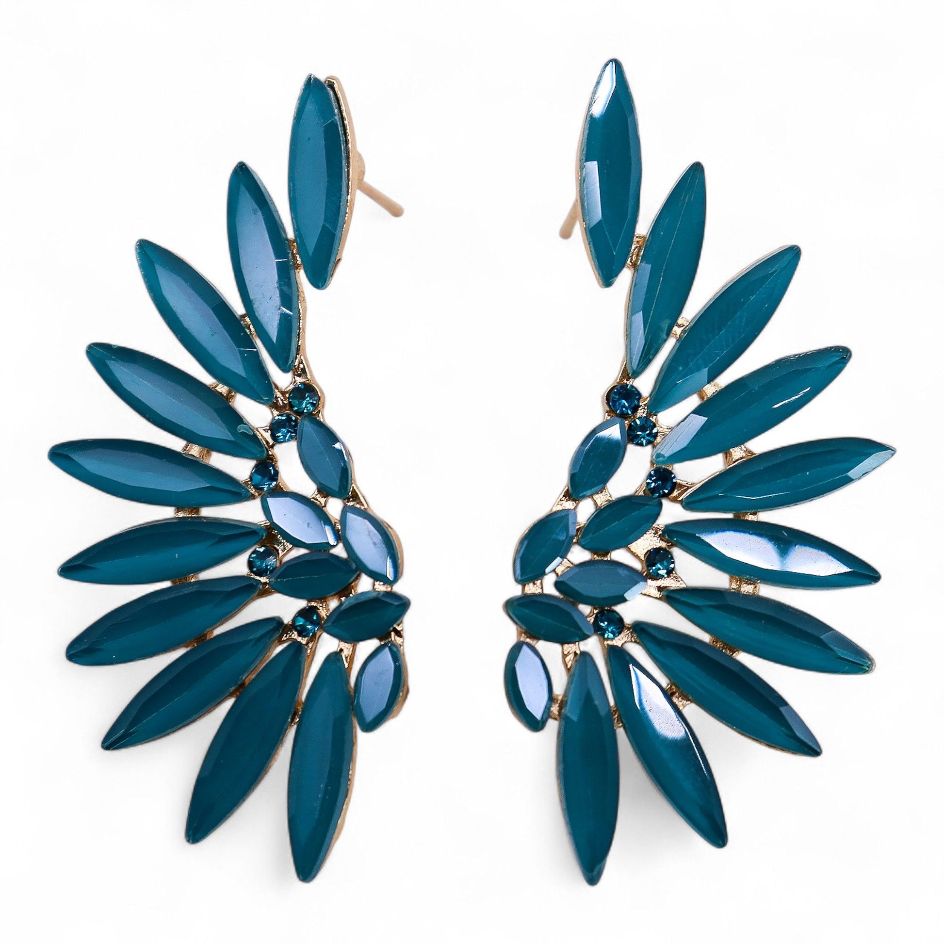 Teal green angel wing earrings with translucent vintage glass and silver stainless steel, hanging against forest backdrop with soft sunlight