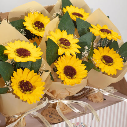 Close-up of sunflower soap flowers dissolving in warm bath, releasing bright yellow swirls and fresh floral scent