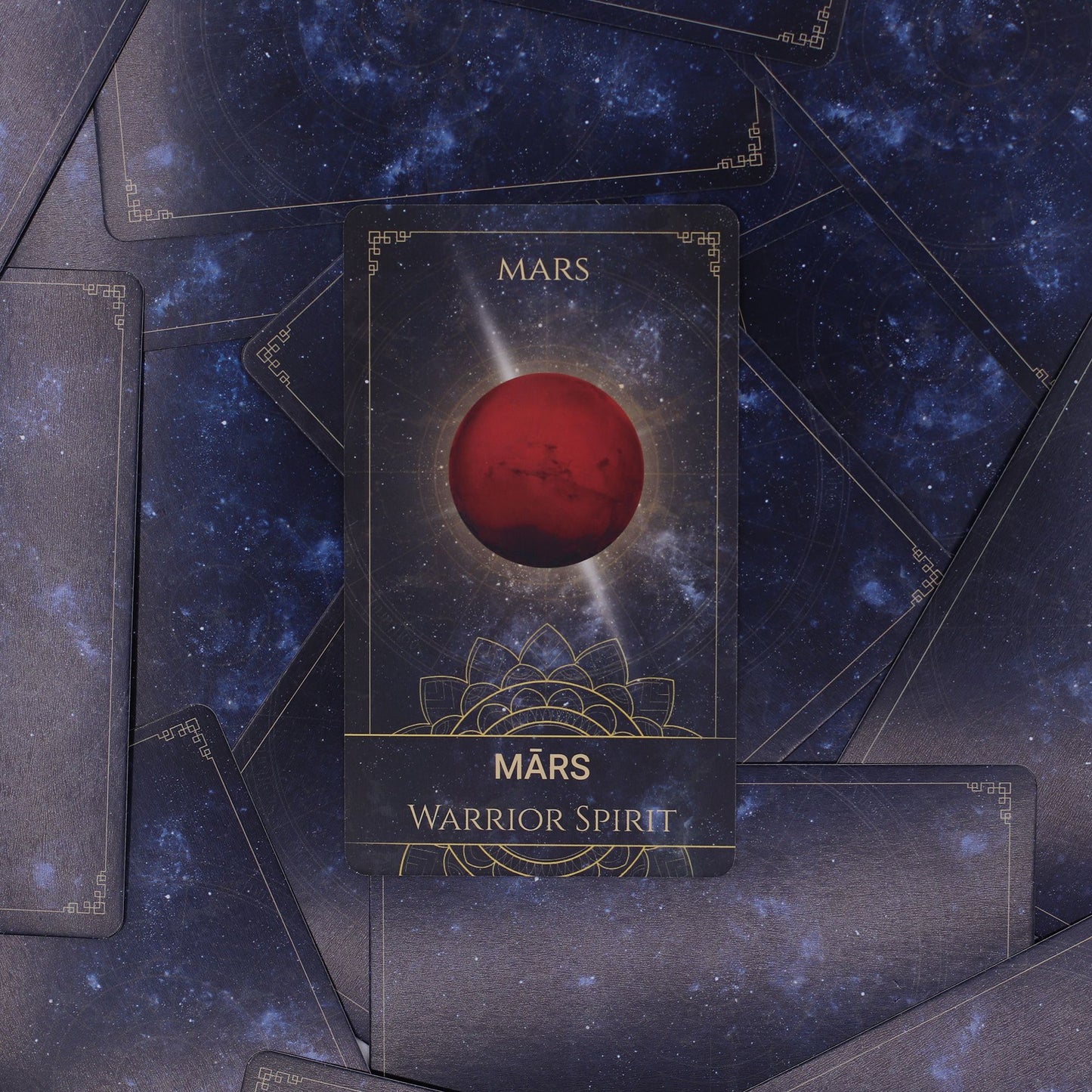Celestial Energy Atlas Oracle Deck fanned out showing midnight blue cards with golden planets, stars & zodiac symbols, box with cosmic design on starry background