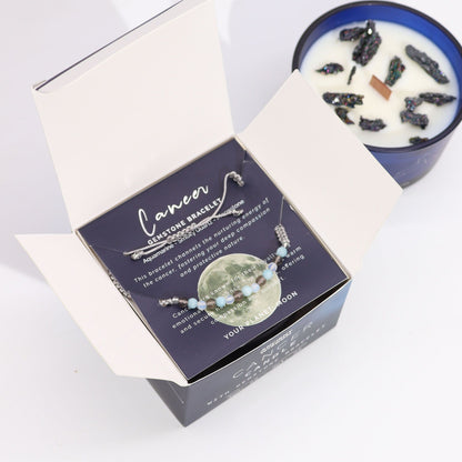 Cancer zodiac bracelet in a box with a candle in the background