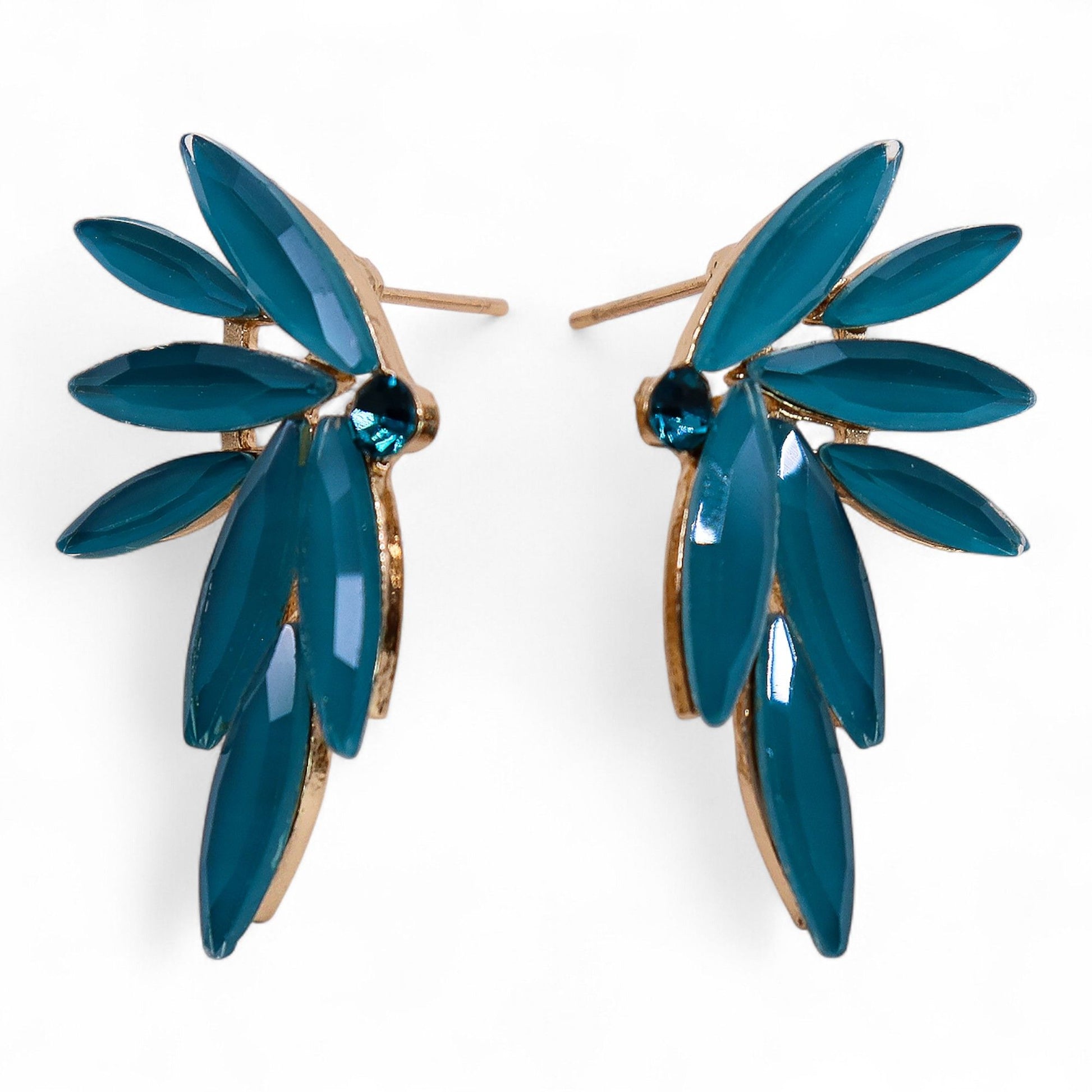 Delicate teal-green fairy wing earrings with translucent vintage glass, glowing softly against moss and forest leaves