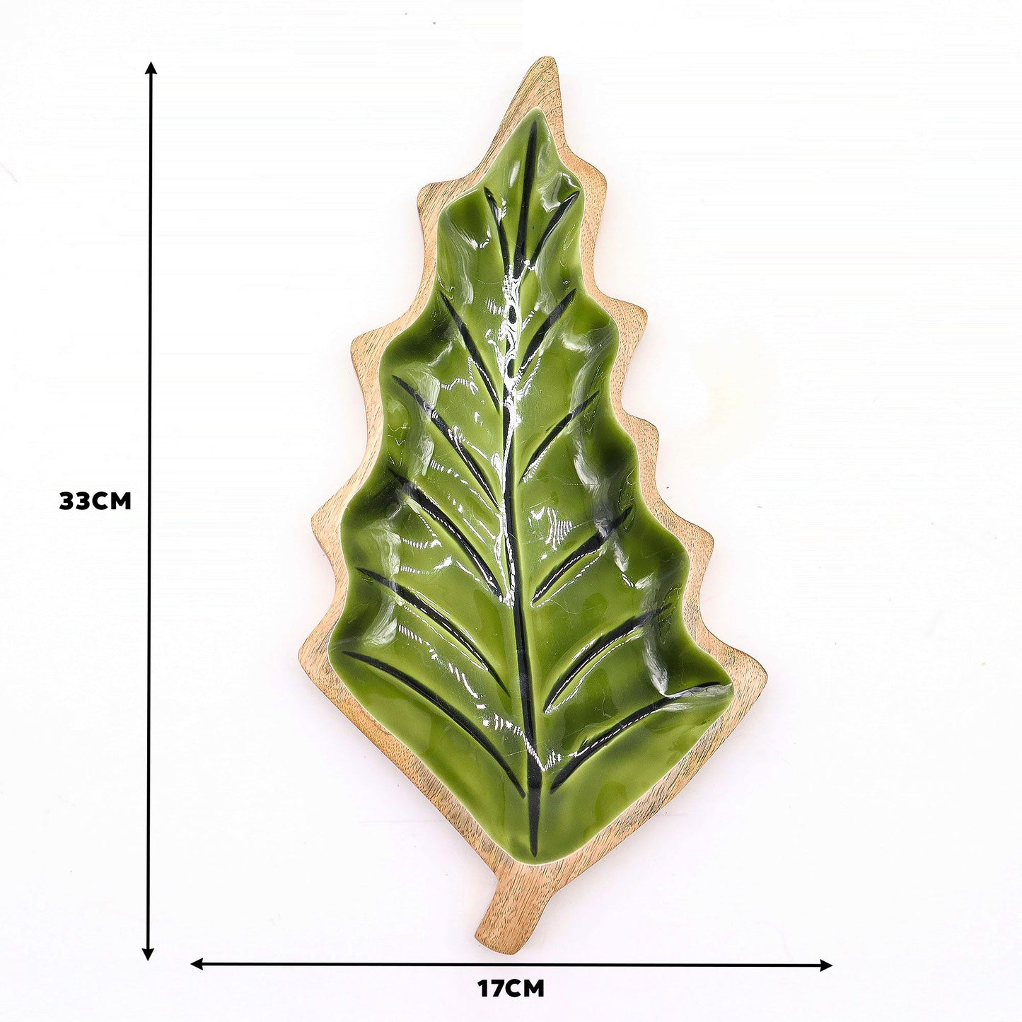Large leaf-shaped mango wood bowl with rich green enamel inside, filled with pine cones and candles on autumn table setting