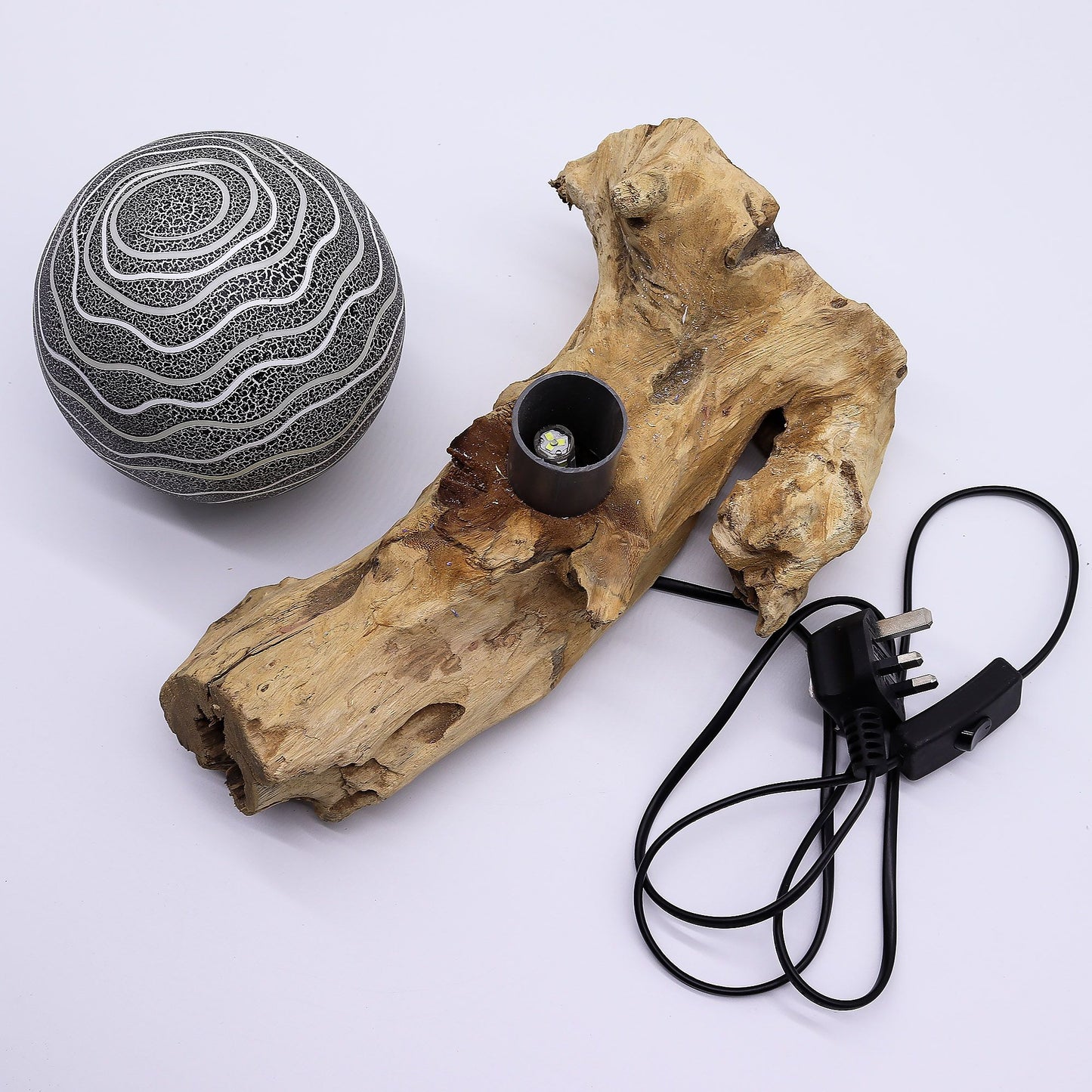 Grey Luna textured sphere glowing softly atop twisted driftwood base
