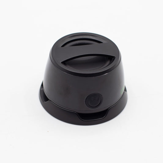 Speaker with included metal ring sticker for non-MagSafe phones, demonstrating universal compatibility