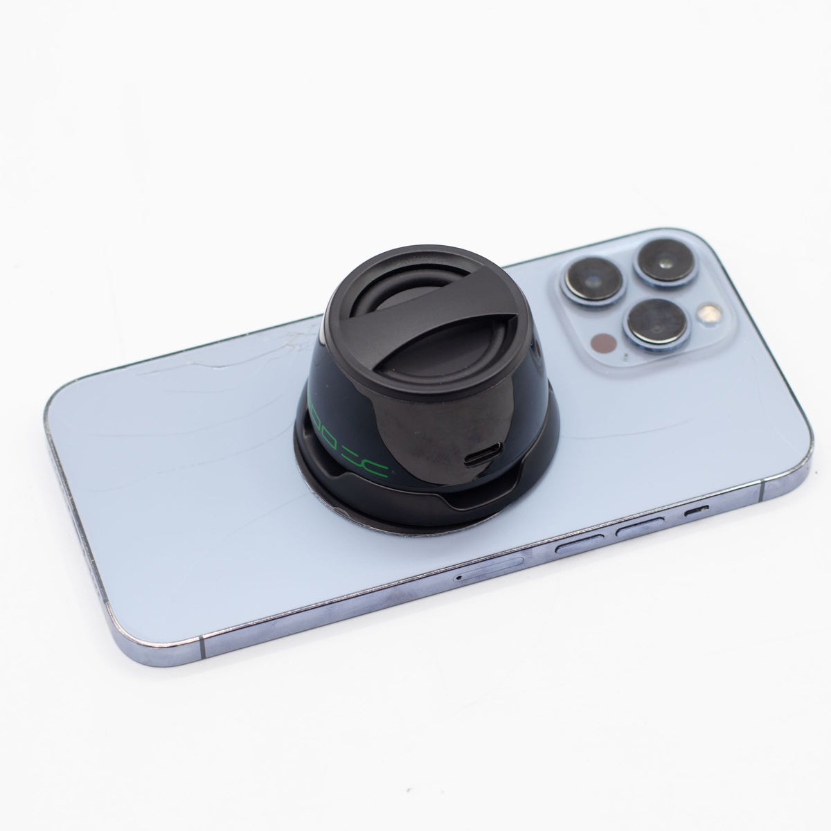 G300 mini speaker snapped onto phone back, propped as stand for hands-free video watching or calls