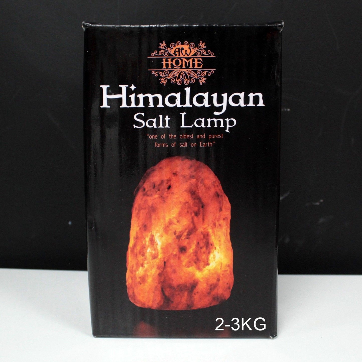 Large 2–3kg natural pink Himalayan salt lamp glowing richly on wooden base