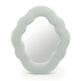 Soft squiggly cloud mirror in serene Cloud Blue velvet frame with smooth rounded silhouette