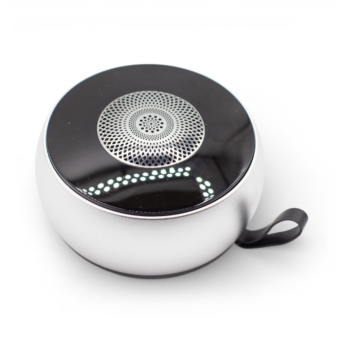 Mini speaker charging via USB cable, 600mAh battery indicator visible, travel-ready size