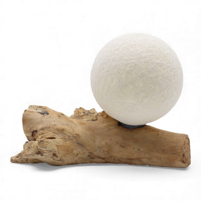 Ivory cotton-wrapped Luna sphere glowing like a full moon atop twisted driftwood base
