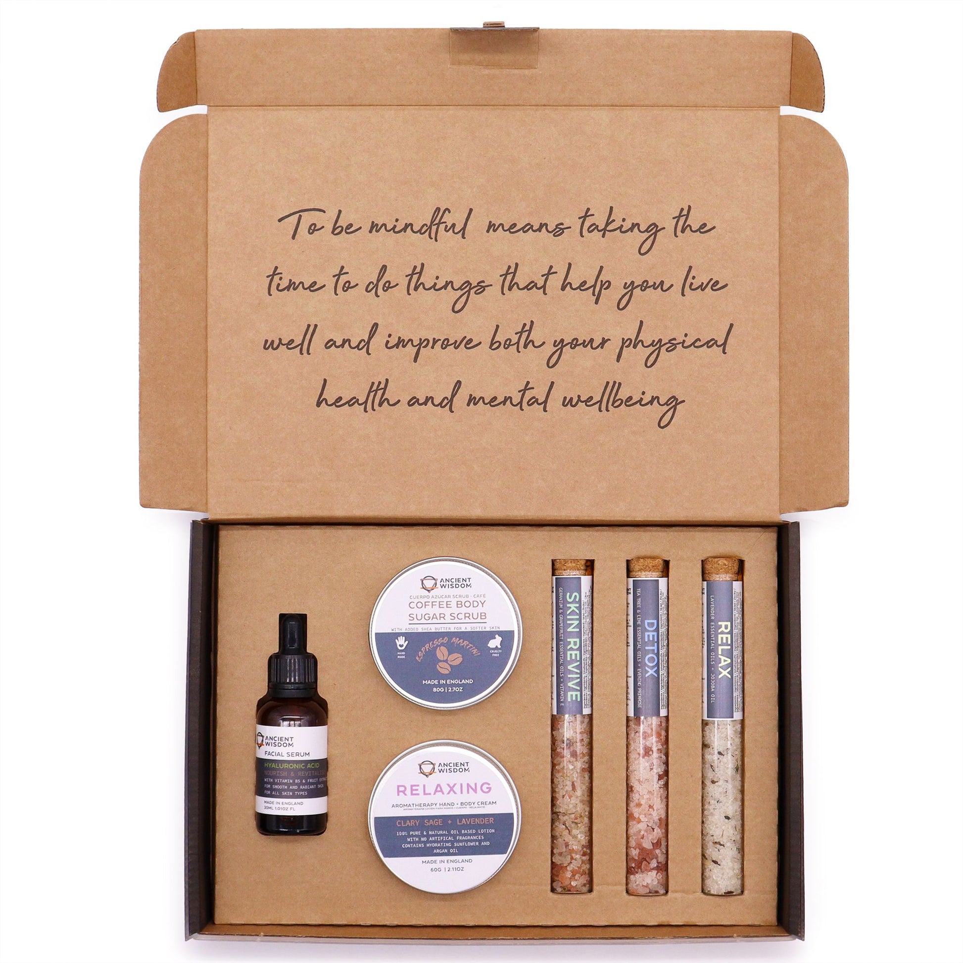 Mindful Moments Self Care Kit in elegant gift box open to reveal coffee sugar scrub jar, body cream, three bath salt vials, hyaluronic acid serum dropper bottle, fresh coffee beans and lavender on marble