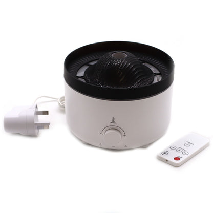 Large black volcano aroma diffuser erupting with swirling coloured mist and glowing LED ring, essential oil bottle beside