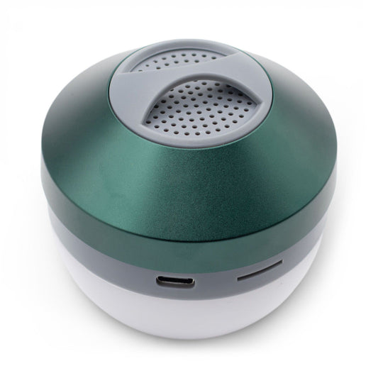 Green Camping Hanging Light & Mini Speaker hanging from tent ceiling with soft LED glow and Bluetooth music playing, compact cube design with carry loop visible