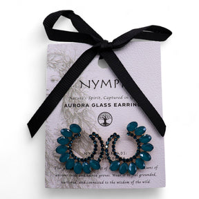 Blue glass earrings on a Nymph branded card with a black ribbon